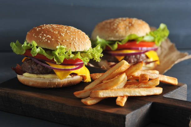 istock Burger with fries on wooden rustic Board 955132344