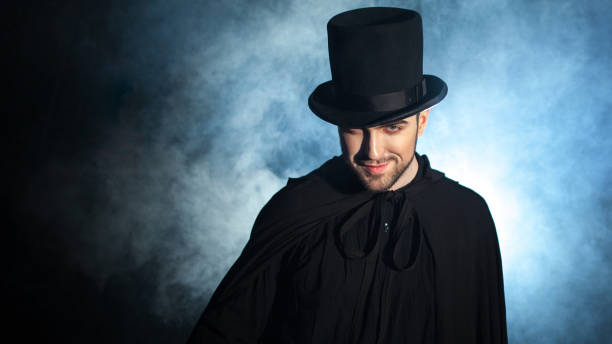 istock Man in a black top hat and cloak. Demonic image. Magician illusionist 955132632