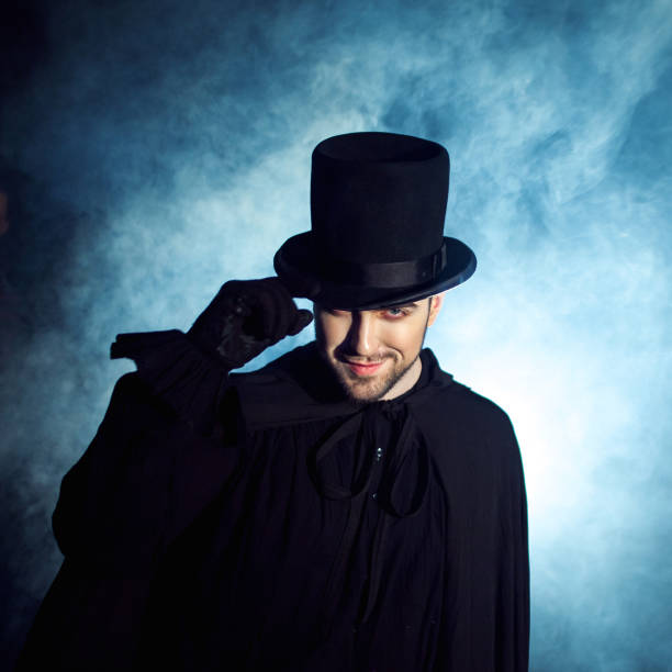 istock Man in a black top hat and cloak. Demonic image. Magician illusionist 955132654