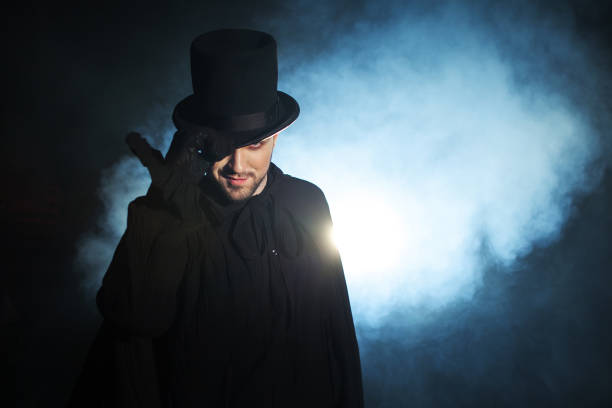 istock Man in a black top hat and cloak. Demonic image. Magician illusionist 955132672