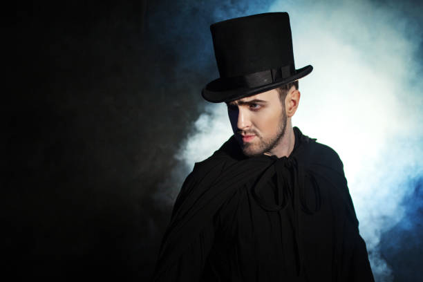 istock Man in a black top hat and cloak. Demonic image. Magician illusionist 955132676