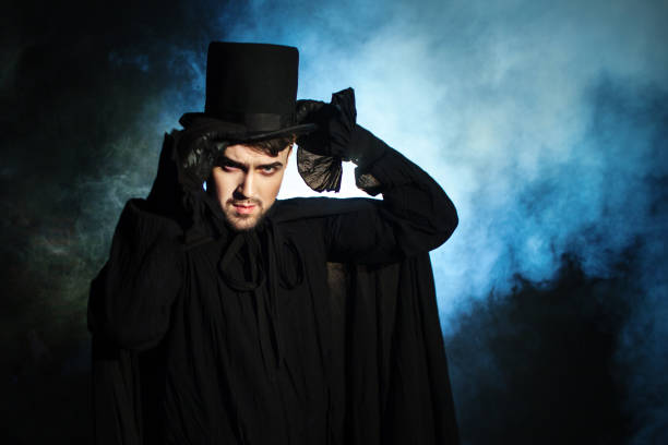 istock Man in a black top hat and cloak. Demonic image. Magician illusionist 955132722