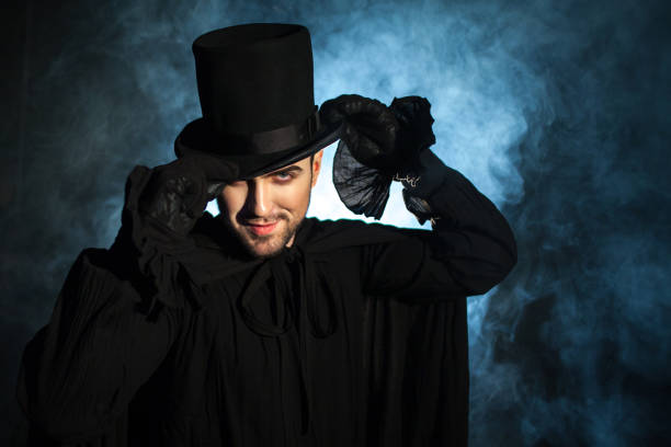 istock Man in a black top hat and cloak. Demonic image. Magician illusionist 955132794