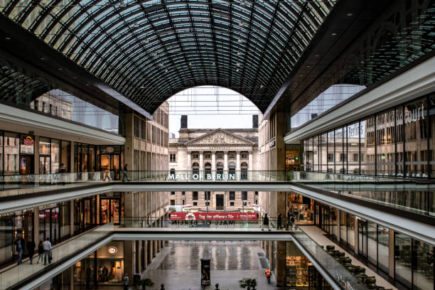 Central Berlin, Germany - April 24, 2018: Inside the court of 'The Mall of Berlin', a big shopping mall in Berlin, Germany, with the Federal Council in the background.