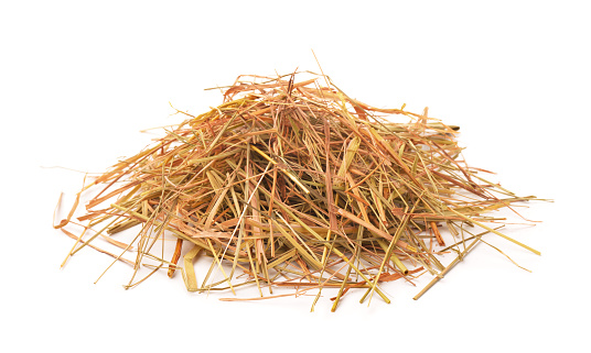 Heap of straw isolated on white