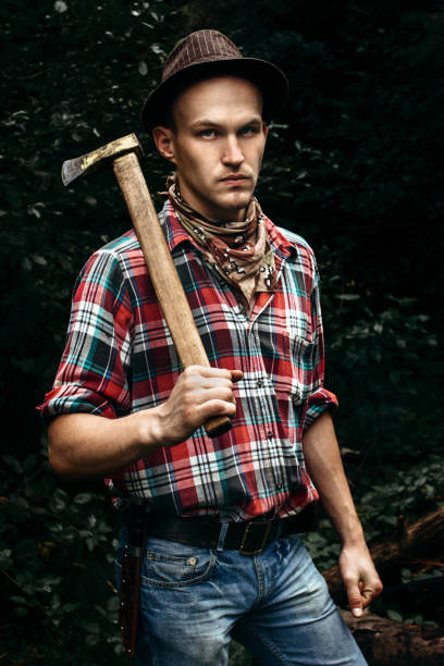 Stylish Hipster Lumberjack With Ax In The Sunny Forest In