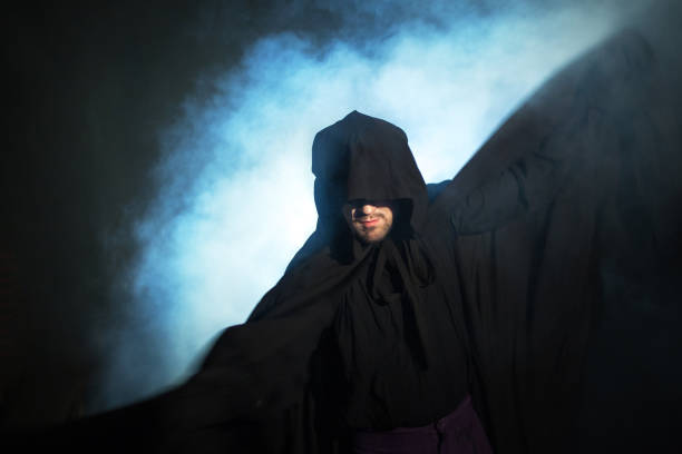 istock Gloomy image. Man in a black cloak. Demonic image. Magician illusionist 955135806