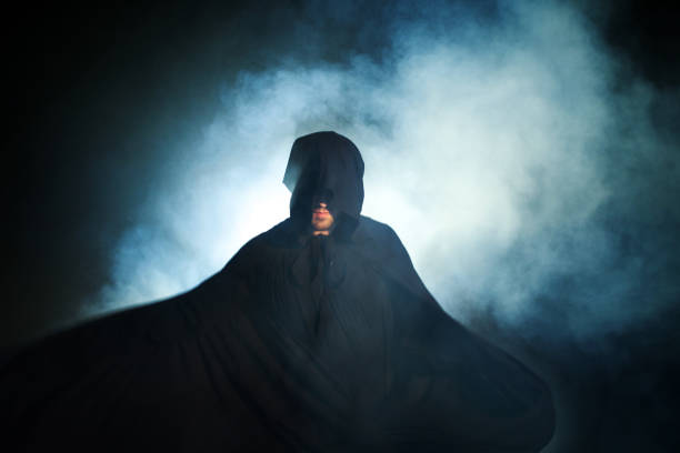 istock Gloomy image. Man in a black cloak. Demonic image. Magician illusionist 955135988
