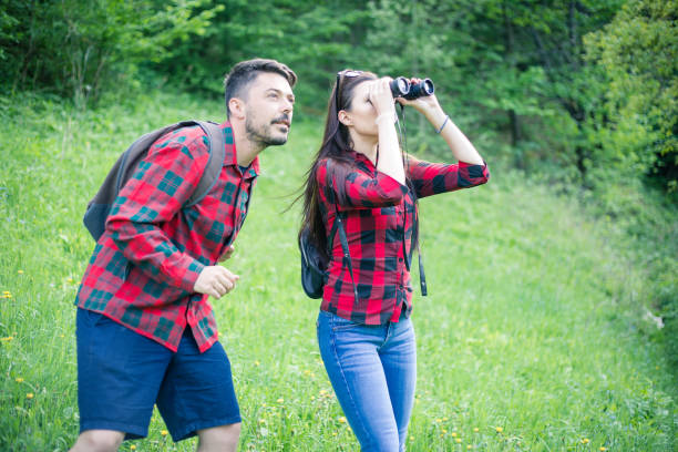 istock Man and woman exploring nature. 955136538