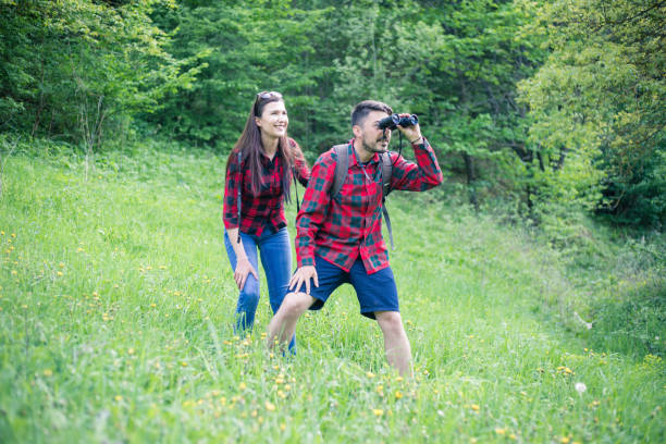 istock Man and woman exploring nature. 955136656