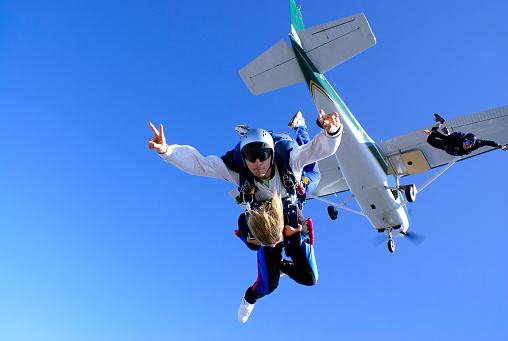 Beautiful girl jumping out of plane