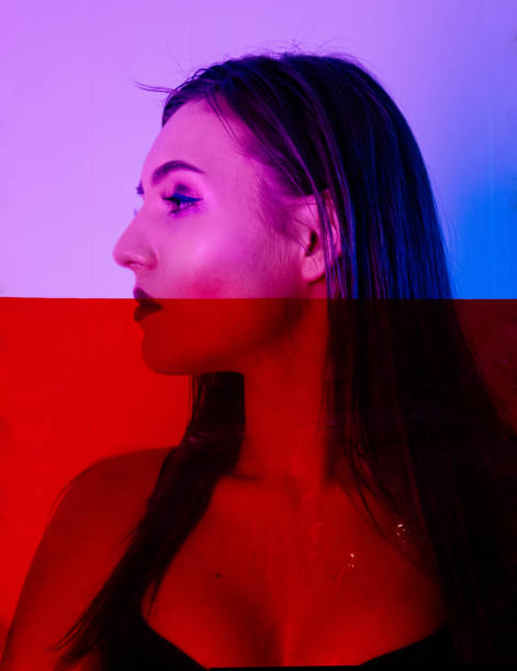 istock Beautiful Woman with Sparkles on her Face in ultraviolet light 955140324