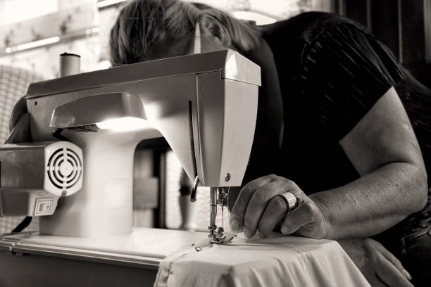 istock Sewing by old women 955144660