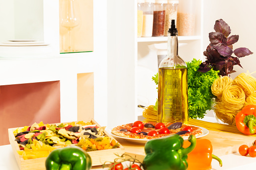 Italian pasta and other food on the table in the kitchen with large assortment