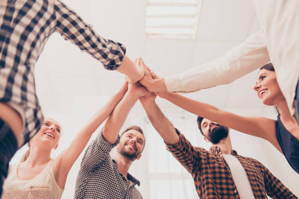 istock People strong when they together. Many holding  hands clasped together 955152962