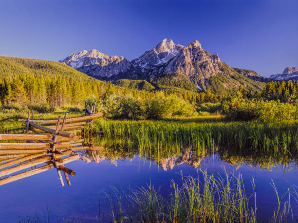 The Sawtooth Mountain Range, Stanley Idaho tranquil getaway; a breathe of fresh air; away from it all; springtime travel adventure, Sawtooth National Forest rail fence stock pictures, royalty-free photos & images