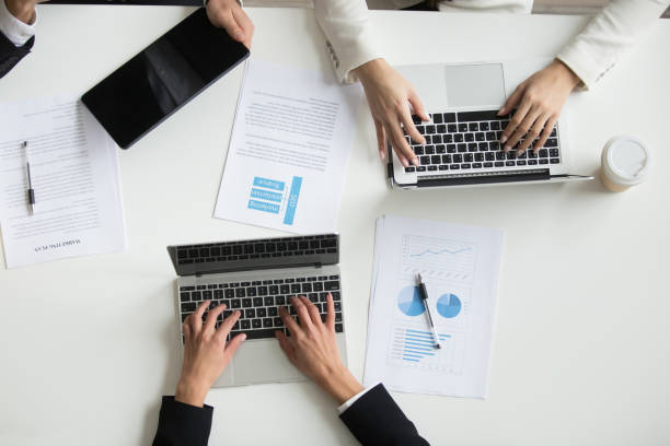 istock Top view of colleagues working with laptops during meeting 955158528