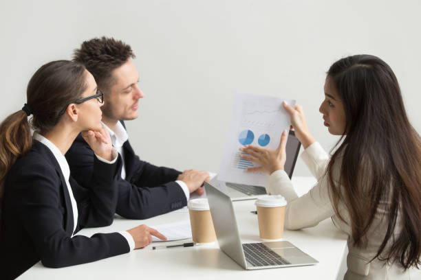 istock Female worker presenting visual templates to coworkers 955158626