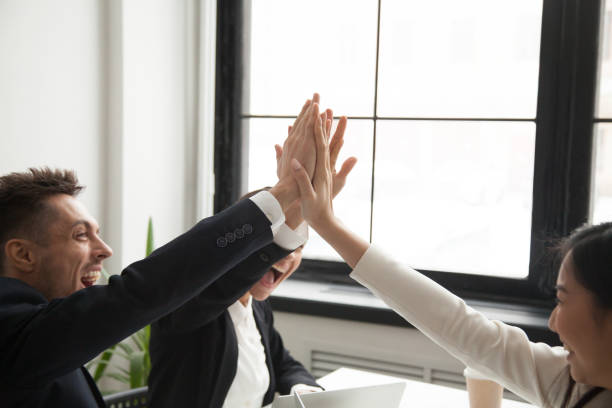 istock Excited colleagues giving high five reaching goal 955158702