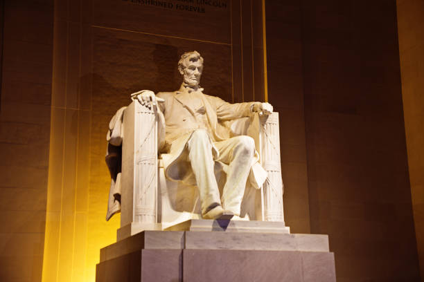 The Lincoln Memorial with President Lincoln Statue in Washington DC The statue of Abraham Lincoln inside the Lincoln Memorial at night, Washington DC, USA. lincoln memorial photos stock pictures, royalty-free photos & images