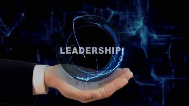 Photo of Painted hand shows concept hologram Leadership on his hand