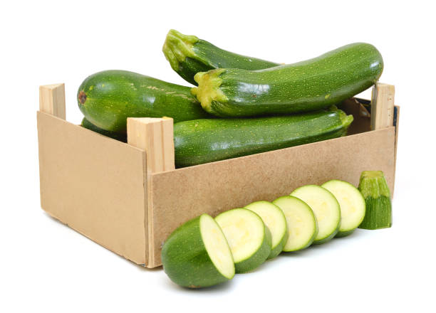 istock fresh zucchini's (Cucurbita pepo) in a wooden crate on a white background 955162786