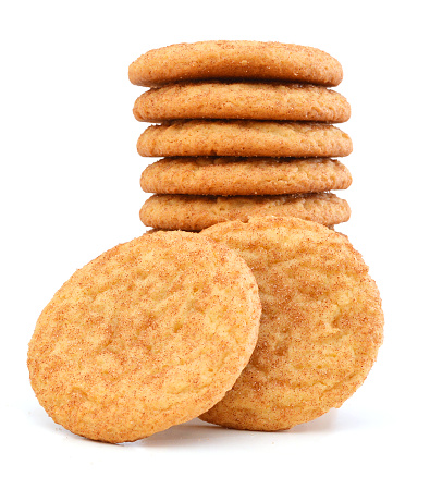 Stack of snickerdoodles over white.