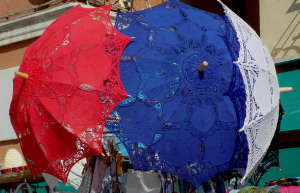 istock Few romantic lace umbrellas, red, blue and white ones 955166100