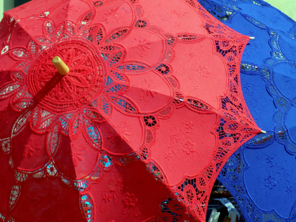 istock Few romantic lace umbrellas, red, blue and white ones 955166106
