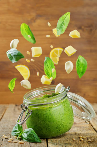 istock Pesto sauce with flying ingredients to prepare it 955169572