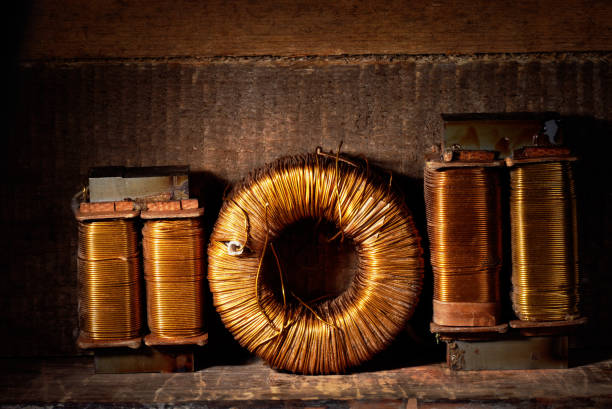 Three old copper wire coils. stock photo
