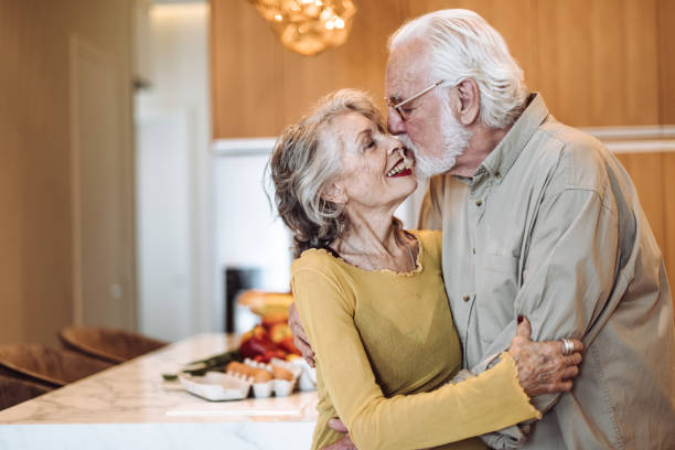 istock senior couple kissing on the kitchen 955169888