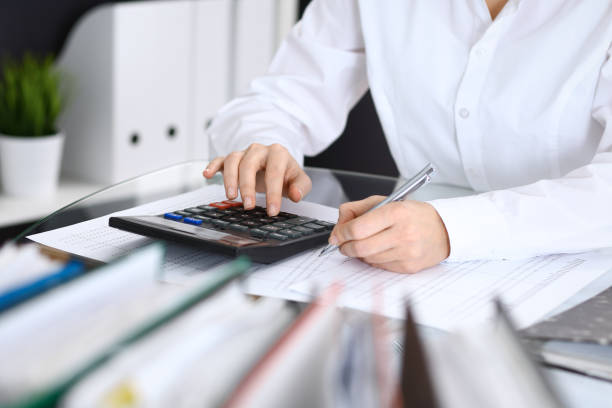 istock Female bookkeeper or financial inspector  making report, calculating or checking balance. Internal Revenue Service checking financial document. Audit concept in busines 955169924
