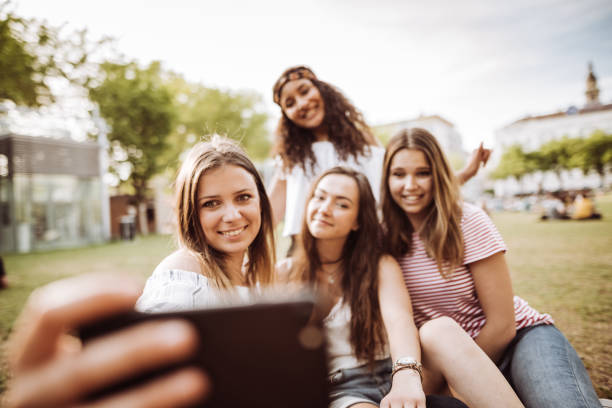 istock friends take a selfie in the park 955172304
