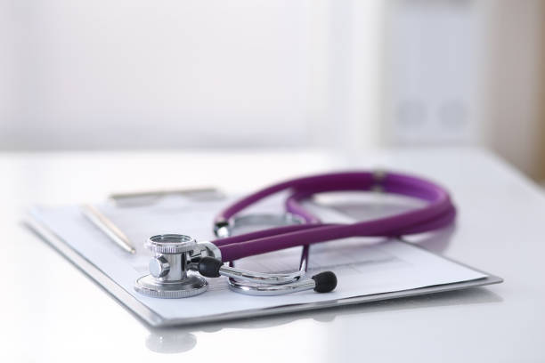 istock Medication history record form lying on table with stethoscope and silver pen. Medicine or pharmacy concept. Medical tools at doctor working table 955172478