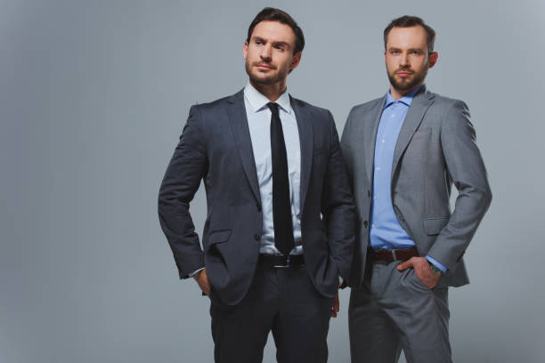 istock serious handsome businessmen isolated on grey 955175518