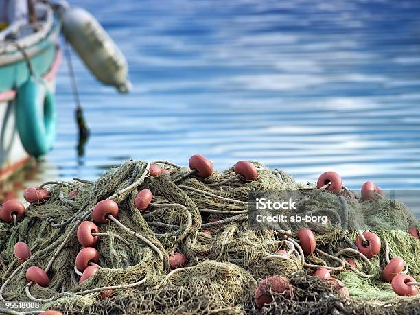 A Mass Of Fishing Nets By A Boat Stock Photo - Download Image Now - Adriatic Sea, Agricultural Equipment, Agriculture