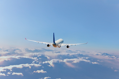 Commercial jet flying over clouds