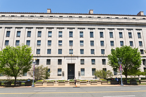 The Department of Justice building in Washington DC. Also known as Justice Department. The Federal organization responsible for the enforcement of the law in United State. A federal executive department of the government.