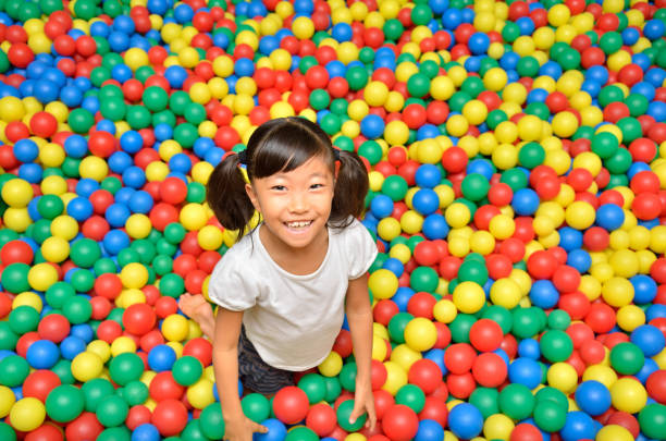 istock Girl's playing with balls 955186282