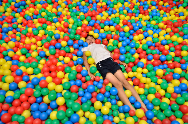 Pile of multicolored plastic balls used in playground or kids ball pit.