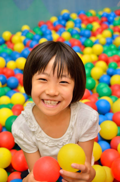 istock Girl's playing with balls 955186398