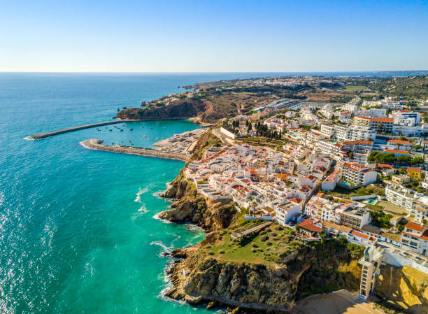 Aerial view of marina and cliffs in Albufeira, Algarve, Portugal Aerial view of marina and white architecture above cliffs in Albufeira, Algarve, Portugal portugal photos stock pictures, royalty-free photos & images