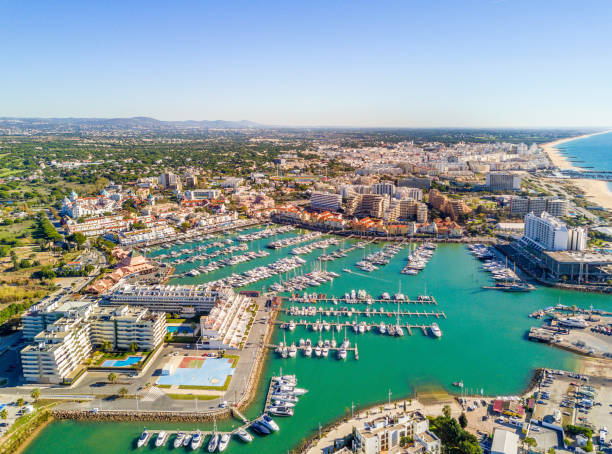 Aerial view of luxurious and touristic Vilamoura, Algarve, Portugal Aerial view of  Vilamoura with charming marina and resorts, Algarve, Portugal faro district portugal photos stock pictures, royalty-free photos & images