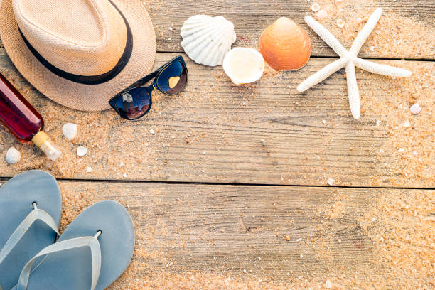 istock Summer hat, shells, sun glasses, tanning oil and flip flops with copy space 955186720