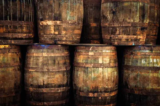 Photo of Stacked old whisky barrels