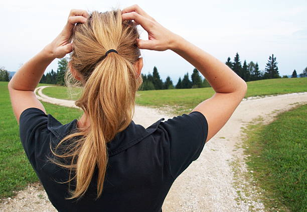 Close up of a woman tying her hair before jogging