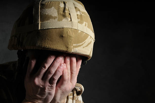 istock A soldier with camouflage helmet with hands covering face 95519052
