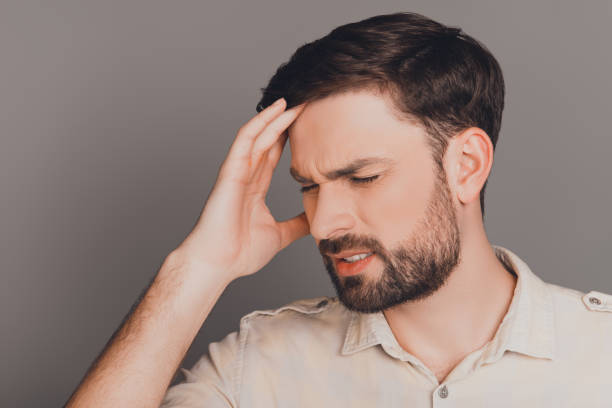 istock Handsome sick man touching head and feeling pain 955191416