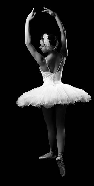 The girl in a ballet suit on black background stock photo